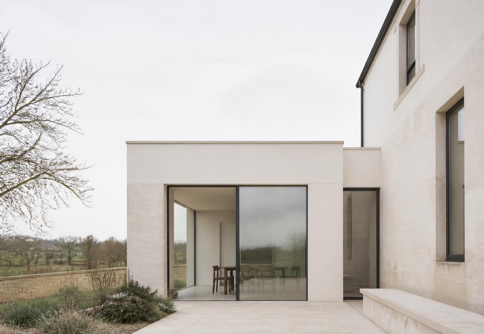 Contemporary limestone house extension with slim-framed glazing in the Oxfordshire countryside